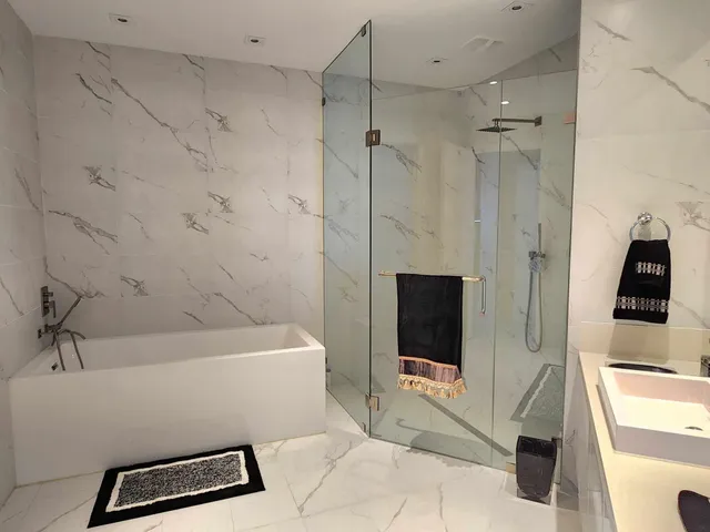 a large bathroom with a double vanity sink a large mirror and bathtub
