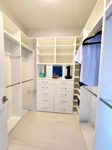 a bedroom with a bed and a dresser next to a window