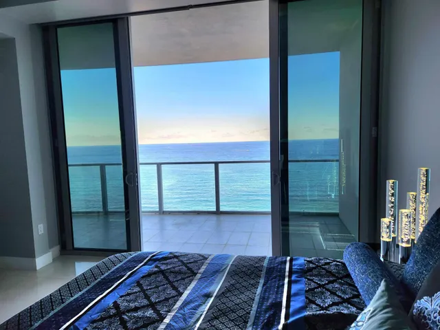 a living room with a bed furniture and a ceiling fan