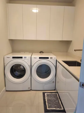 a bathroom with a sink and mirror with toilet
