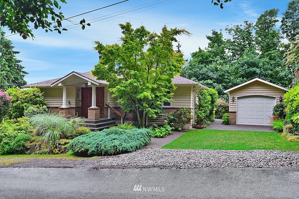 4402 Southwest Rose Street Seattle, WA 98136 - Photo 1 of 20 a view of a house with a small yard and large tree