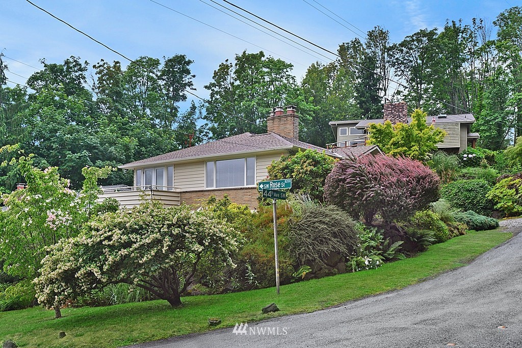 4402 Southwest Rose Street Seattle, WA 98136 - Photo 2 of 20 a view of a house with a yard
