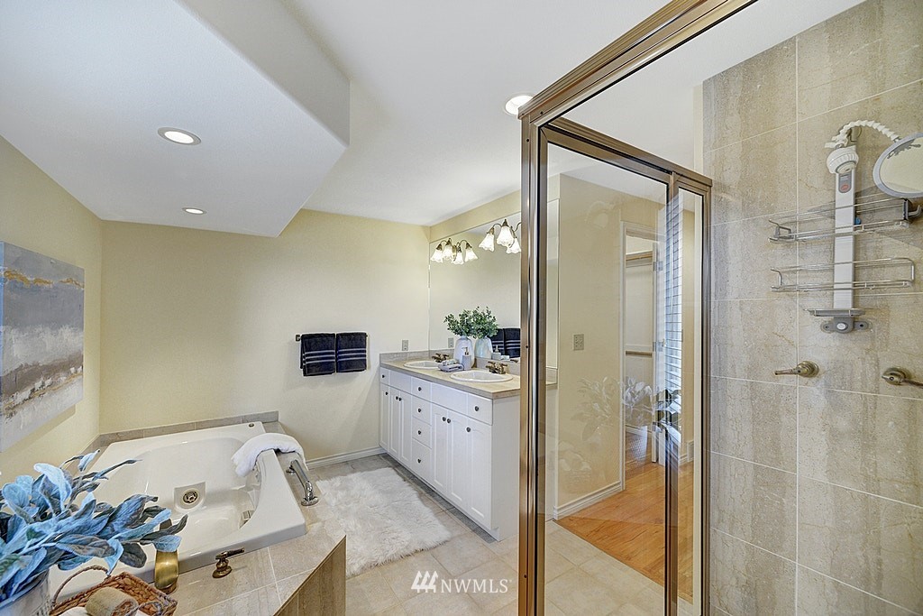 4402 Southwest Rose Street Seattle, WA 98136 - Photo 12 of 20 a bathroom with a tub sink and mirror