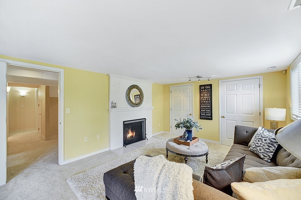 4402 Southwest Rose Street Seattle, WA 98136 - Photo 15 of 20 a living room with furniture and a fireplace