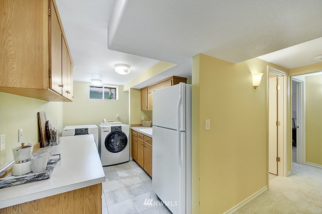 4402 Southwest Rose Street Seattle, WA 98136 - Photo 17 of 20 a utility room with refrigerator and washer