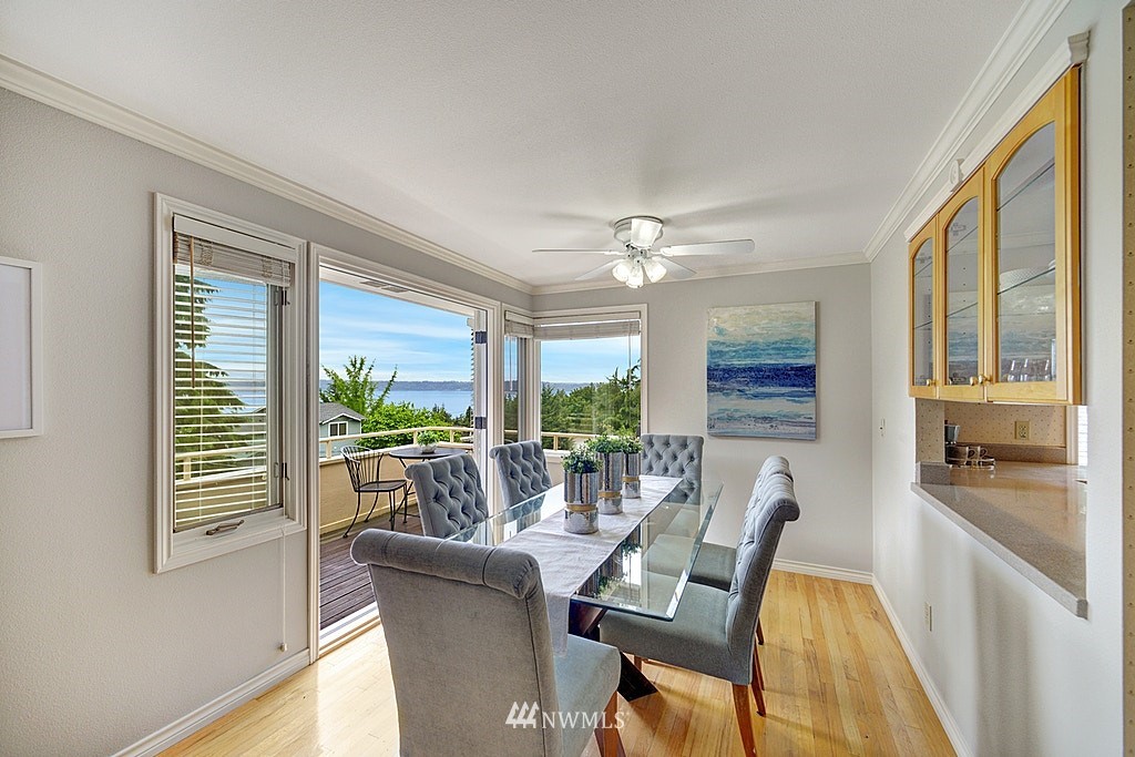 4402 Southwest Rose Street Seattle, WA 98136 - Photo 5 of 20 a dining room with furniture a chandelier and wooden floor