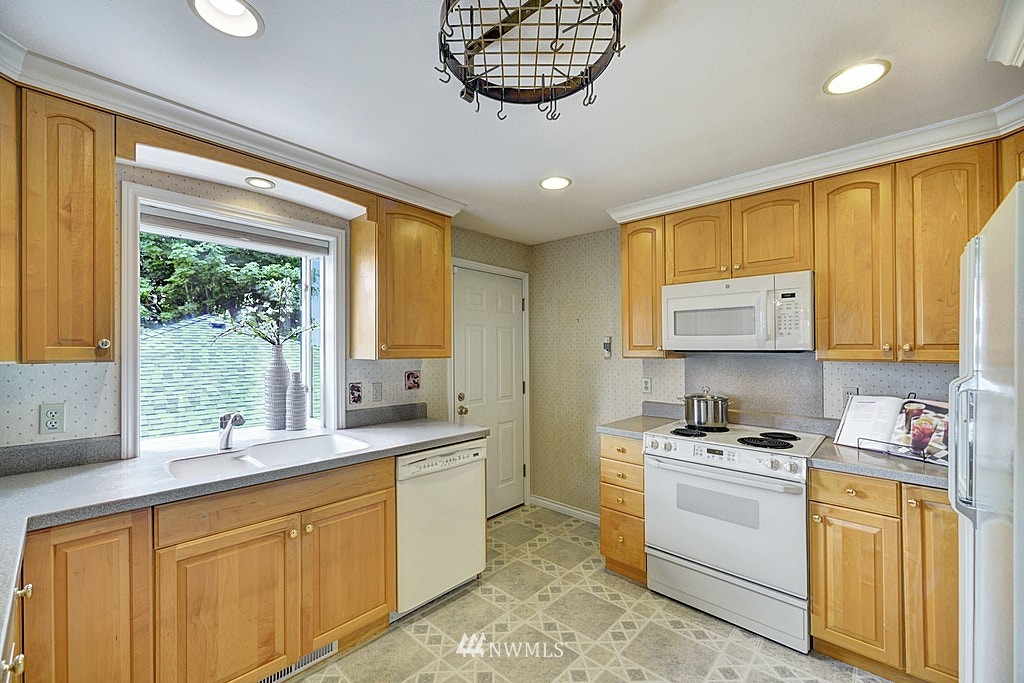 4402 Southwest Rose Street Seattle, WA 98136 - Photo 6 of 20 a kitchen with sink cabinets and window