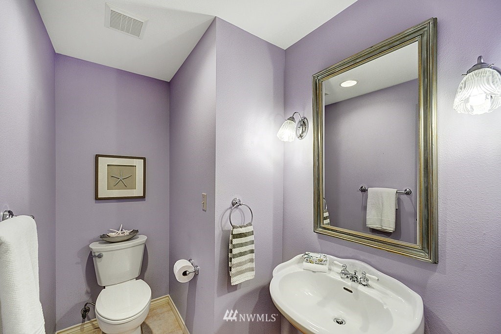 4402 Southwest Rose Street Seattle, WA 98136 - Photo 8 of 20 a bathroom with a toilet sink and mirror