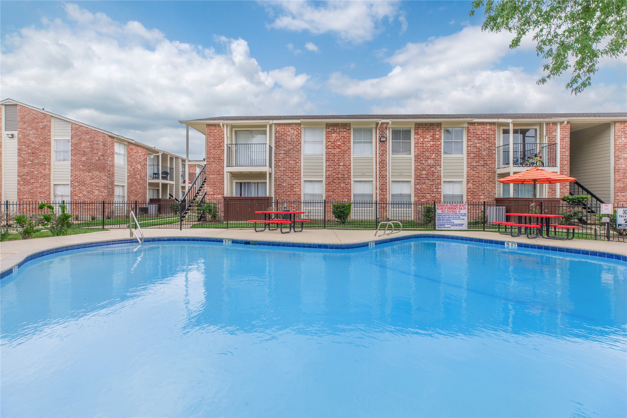 3401 Ocee Street, Unit 304 Houston, TX 77063 - Photo 4 of 6 a view of pool with lawn chairs and floor to ceiling window and wooden fence