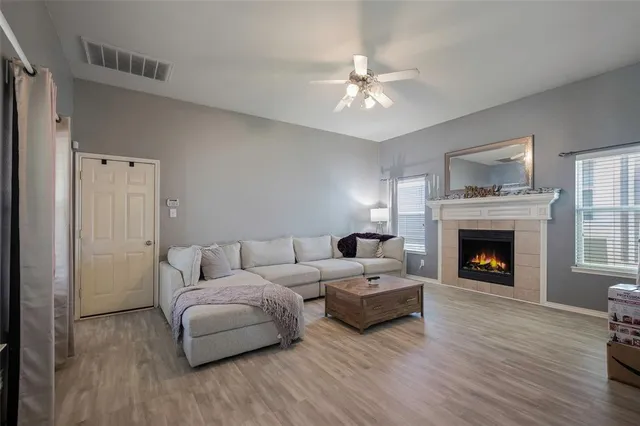 a living room with furniture and a fireplace