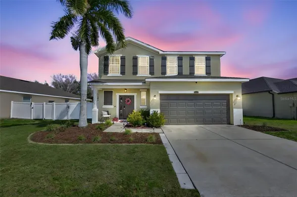 a front view of a house with a yard and garage