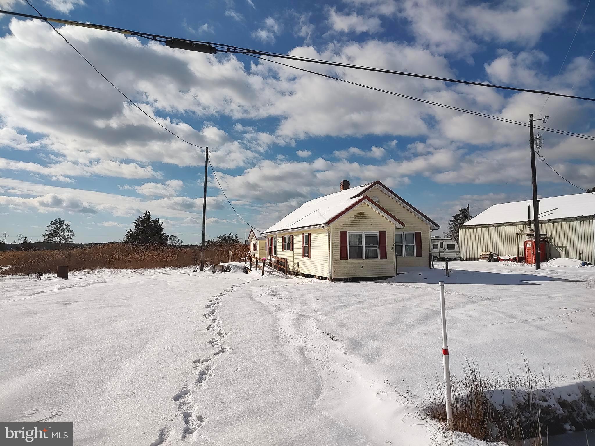 2703 Toddville Road Toddville, MD 21672 - Photo 2 of 24 a view of a house with a snow in the yard