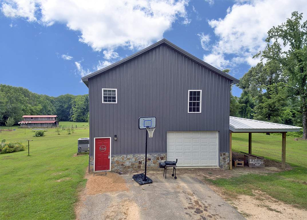 175 Poplar Corner Road Bells, TN 38006 - Photo 1 of 1 a backyard of a house with table and chairs