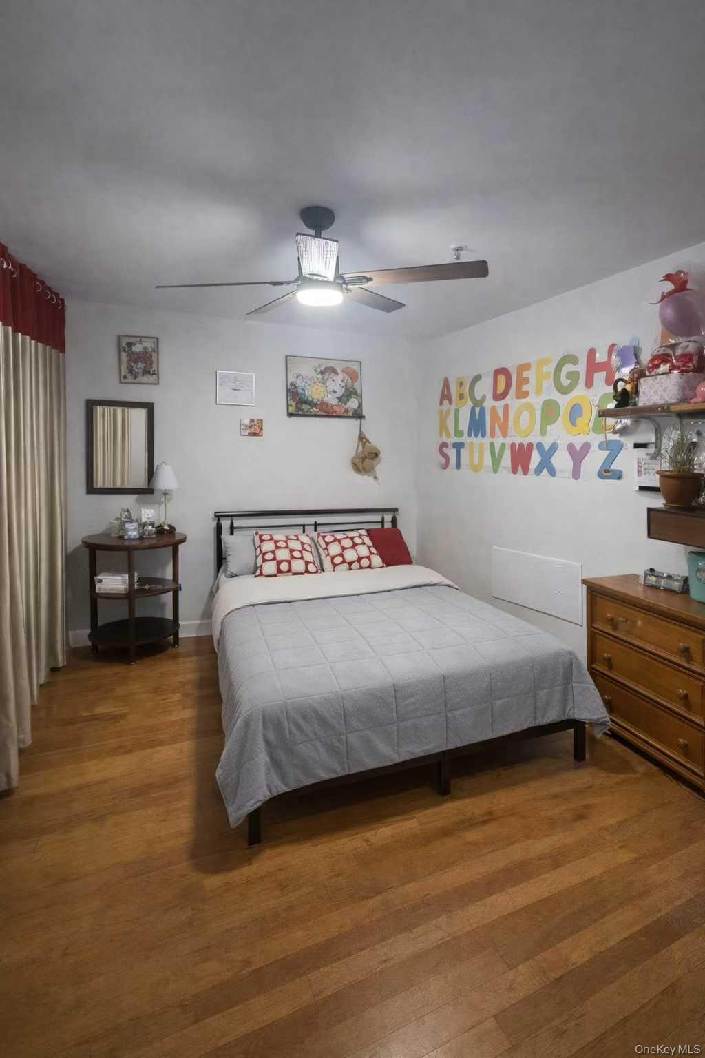 37-33 107th Street, Unit 4A Queens, NY 11368 - Photo 4 of 7 a bedroom with a bed and dresser