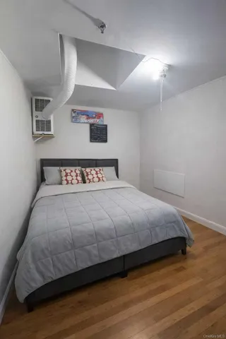 a bedroom with a bed and painting on the wall