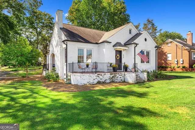 a front view of house with yard and green space