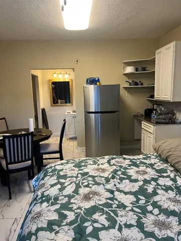 a room with a bed and a television