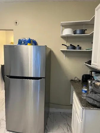 a white refrigerator freezer sitting in a kitchen
