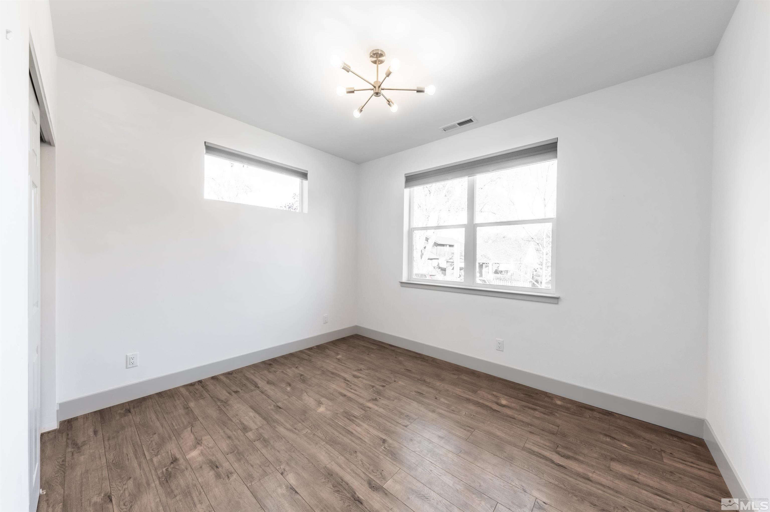 1217 Lander Street Reno, NV 89509 - Photo 11 of 21 an empty room with windows and a ceiling fan
