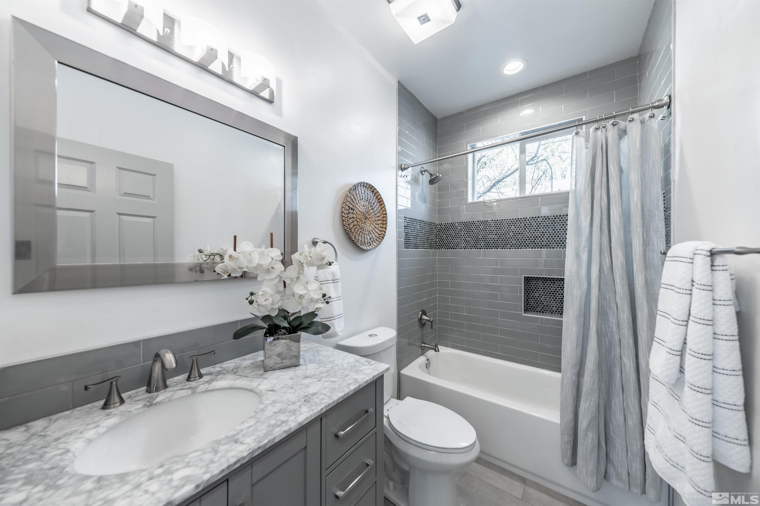 1217 Lander Street Reno, NV 89509 - Photo 12 of 21 a bathroom with a granite countertop sink toilet and shower