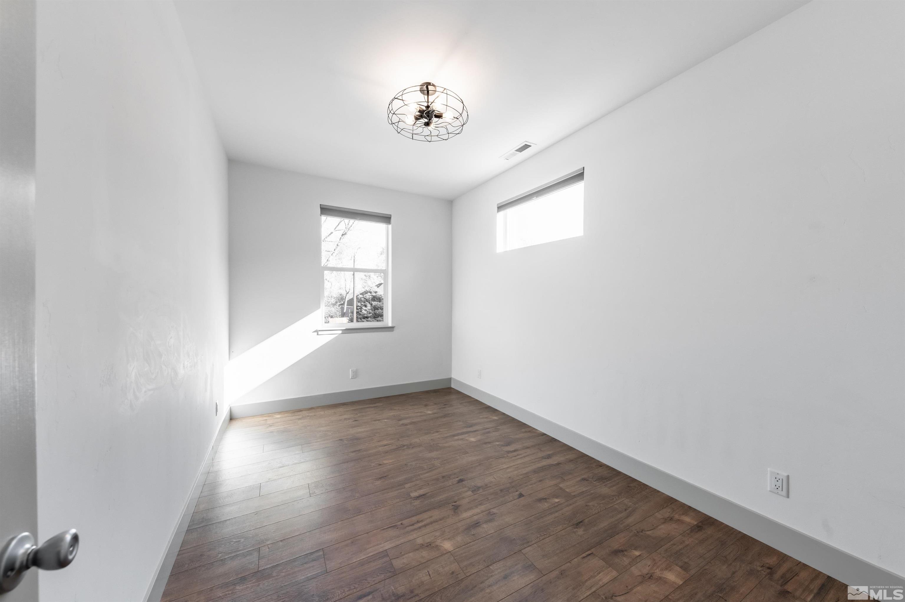 1217 Lander Street Reno, NV 89509 - Photo 13 of 21 an empty room with wooden floor and windows