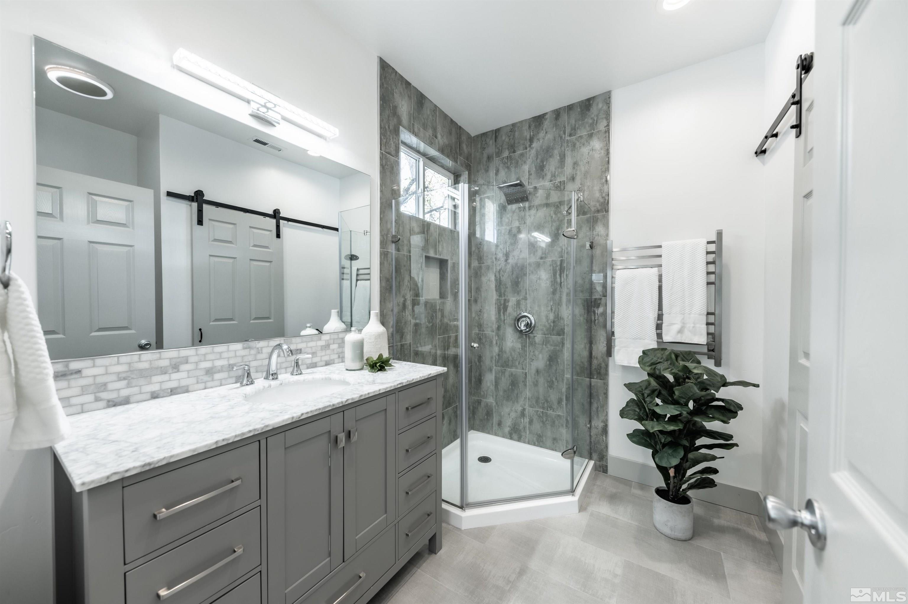 1217 Lander Street Reno, NV 89509 - Photo 9 of 21 a bathroom with a double vanity sink mirror and bathtub