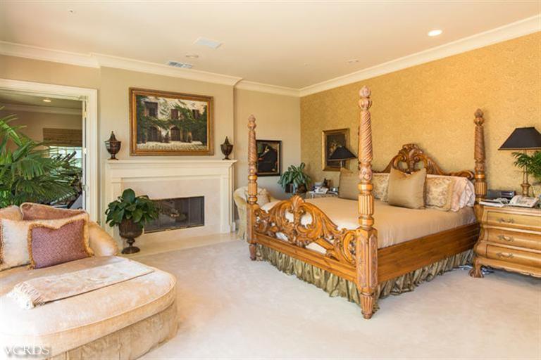 2702 Ladbrook Way Thousand Oaks, CA 91361 - Photo 18 of 45 a spacious bedroom with a bed a couch and fireplace