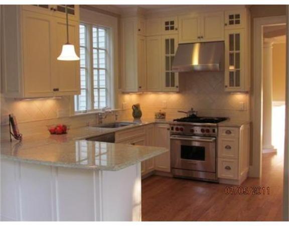 6 Rice Street, Unit 1 Wellesley, MA 02481 - Photo 2 of 8 a kitchen with stainless steel appliances granite countertop a stove a sink and a refrigerator