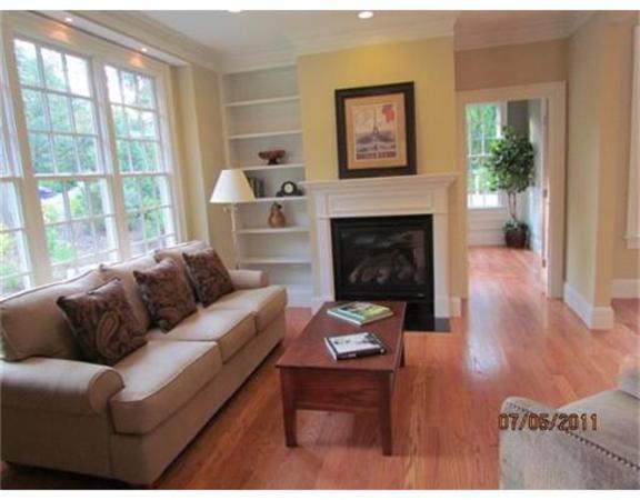 6 Rice Street, Unit 1 Wellesley, MA 02481 - Photo 3 of 8 a living room with furniture a large window and a fireplace