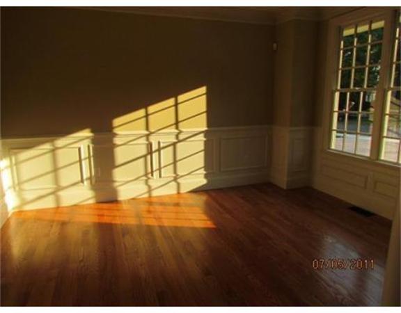 6 Rice Street, Unit 1 Wellesley, MA 02481 - Photo 4 of 8 a view of an empty room with a window