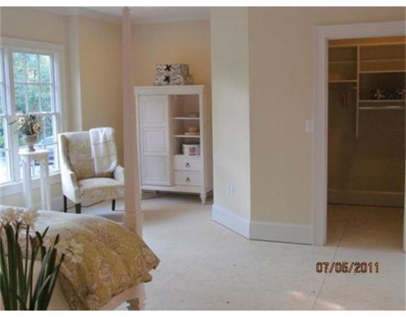 6 Rice Street, Unit 1 Wellesley, MA 02481 - Photo 6 of 8 a bedroom with a bed and a chair