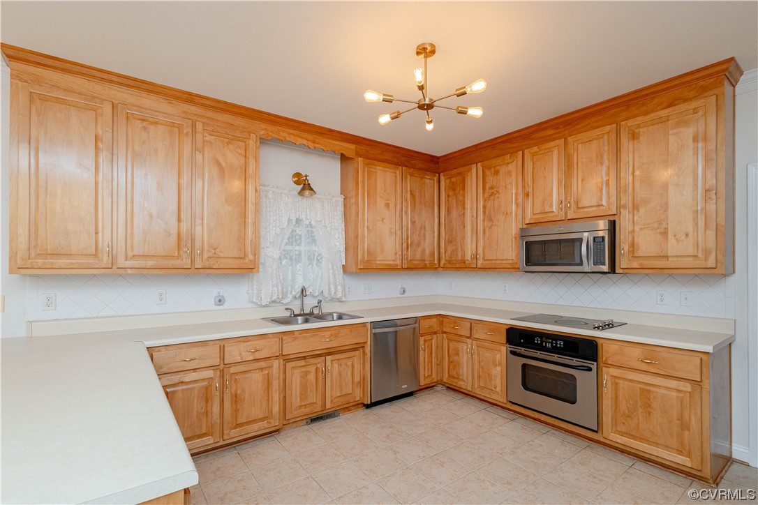 12904 Chipstead Road Chester, VA 23831 - Photo 17 of 50 a kitchen with stainless steel appliances granite countertop a sink and cabinets