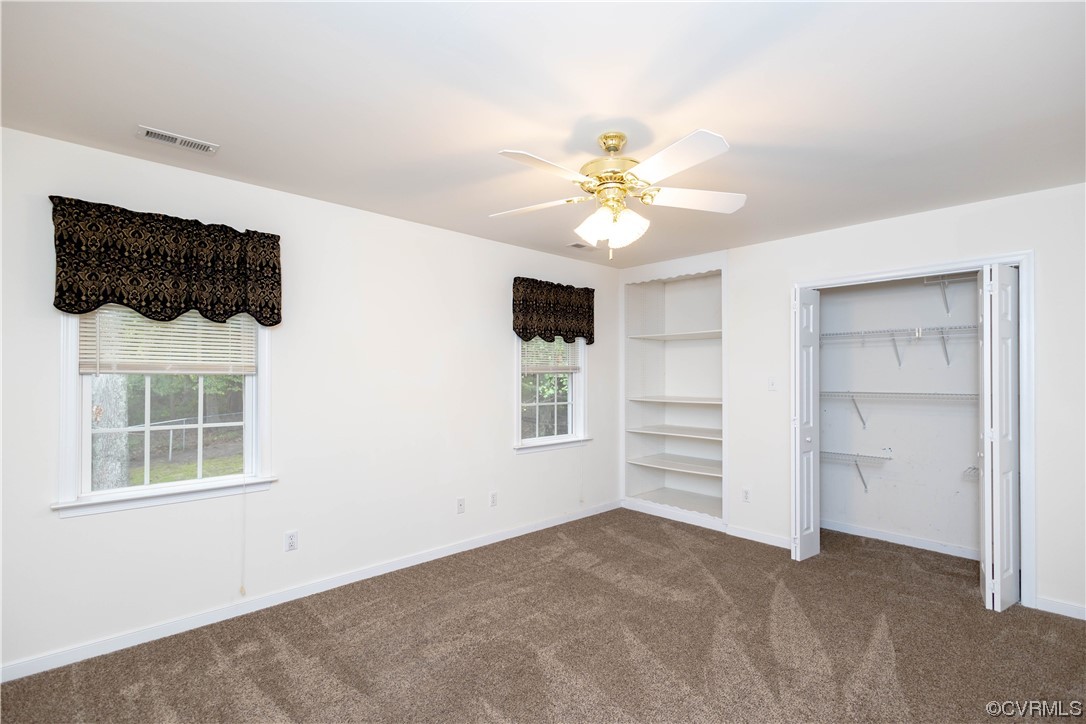 12904 Chipstead Road Chester, VA 23831 - Photo 23 of 50 a view of a bedroom with a ceiling fan and a window