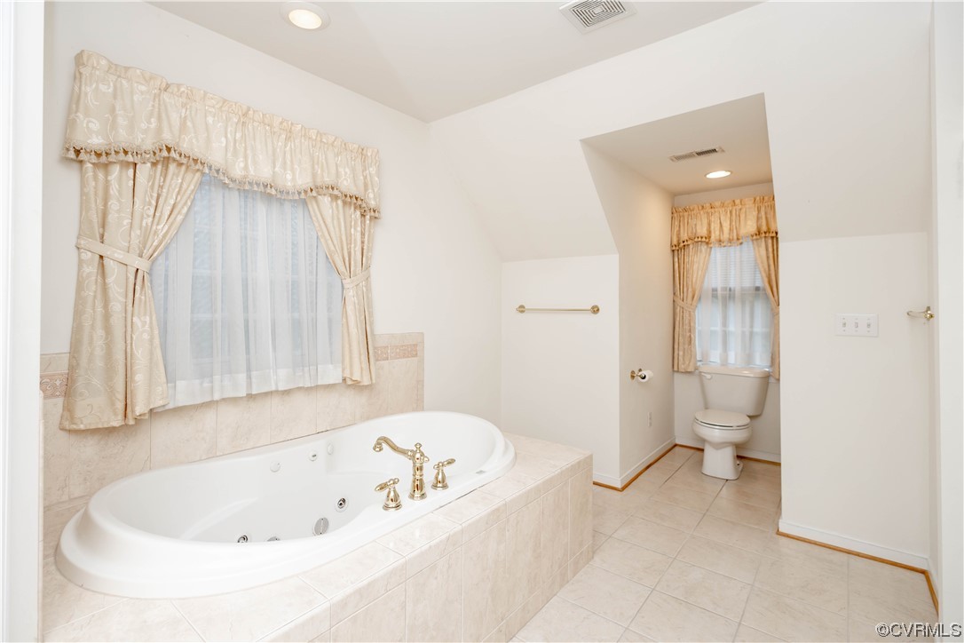 12904 Chipstead Road Chester, VA 23831 - Photo 34 of 50 a white bath tub sitting next to a white toilet