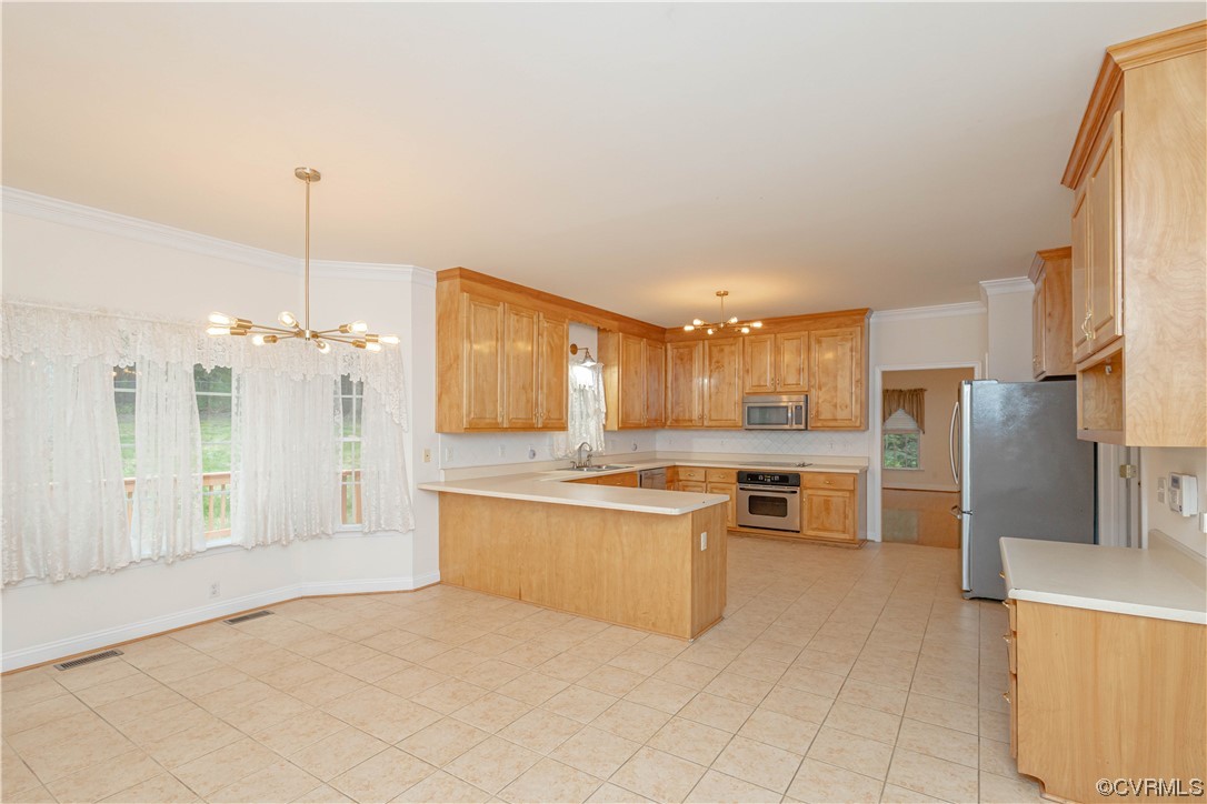 12904 Chipstead Road Chester, VA 23831 - Photo 10 of 50 a kitchen with stainless steel appliances kitchen island granite countertop a refrigerator and a sink
