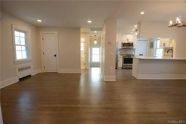 a view of kitchen with cabinets and wooden floor