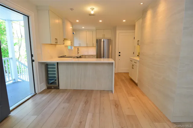 a large kitchen with a lot of counter space and wooden floor
