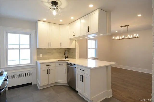 a kitchen that has a lot of cabinets in it and a window