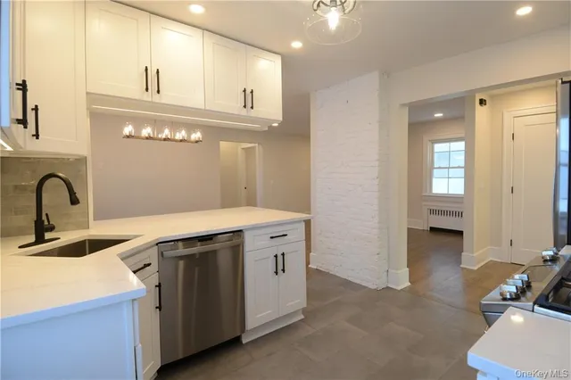 a view of a bathroom with a sink and a mirror