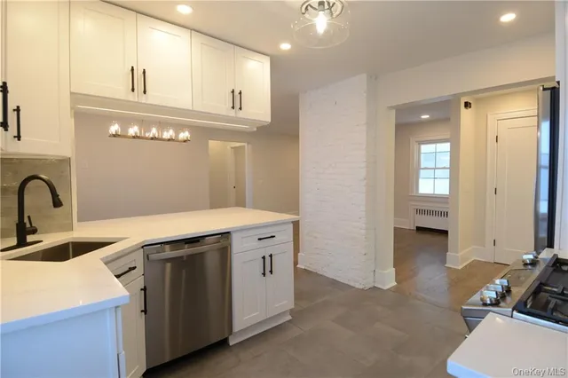 a kitchen that has a sink and a stove