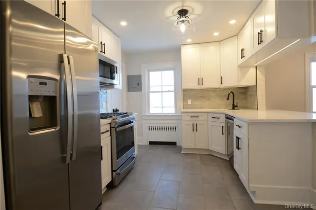 a kitchen with a sink stainless steel appliances and cabinets