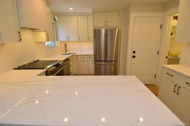 a kitchen with a refrigerator and a sink