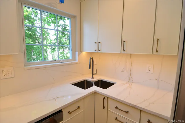 a kitchen with a sink and cabinets