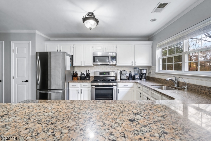 42 Springfield Road North Brunswick, NJ 08902 - Photo 11 of 29 a kitchen with granite countertop a refrigerator and a sink