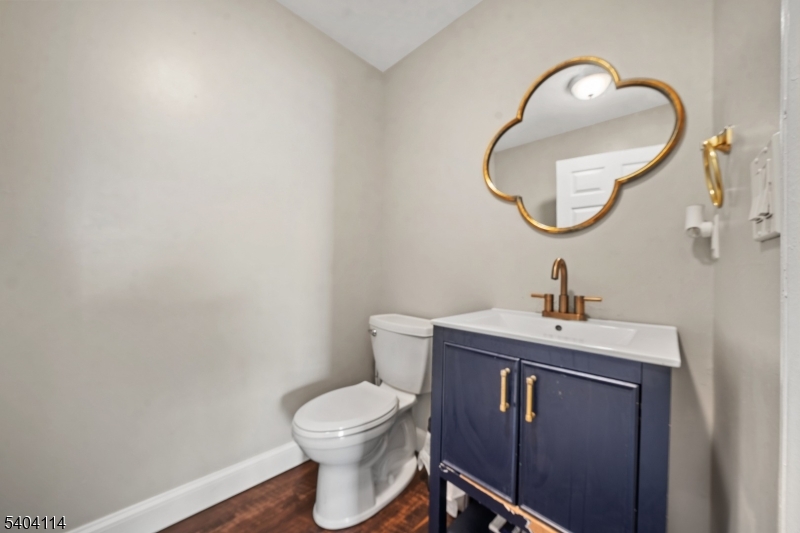 42 Springfield Road North Brunswick, NJ 08902 - Photo 15 of 29 a bathroom with a toilet a sink and mirror