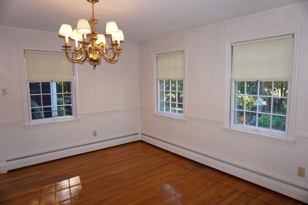32 McGregory Road Sturbridge, MA 01566 - Photo 13 of 28 an empty room with wooden floor chandelier and windows