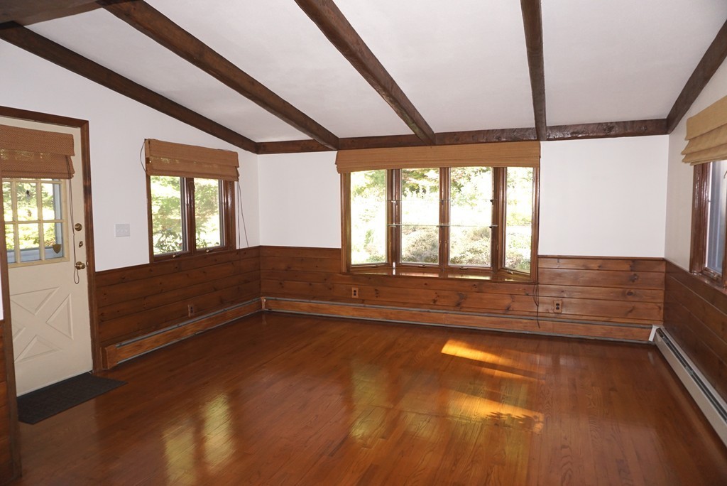 32 McGregory Road Sturbridge, MA 01566 - Photo 3 of 28 a view of an empty room with wooden floor and a window