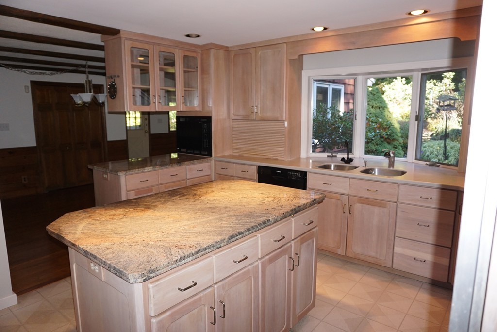 32 McGregory Road Sturbridge, MA 01566 - Photo 7 of 28 a kitchen with a stove a sink and a wooden cabinets