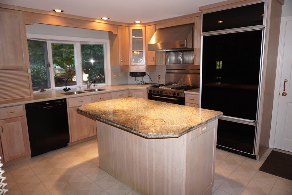32 McGregory Road Sturbridge, MA 01566 - Photo 8 of 28 a kitchen with a sink a counter top space and stainless steel appliances