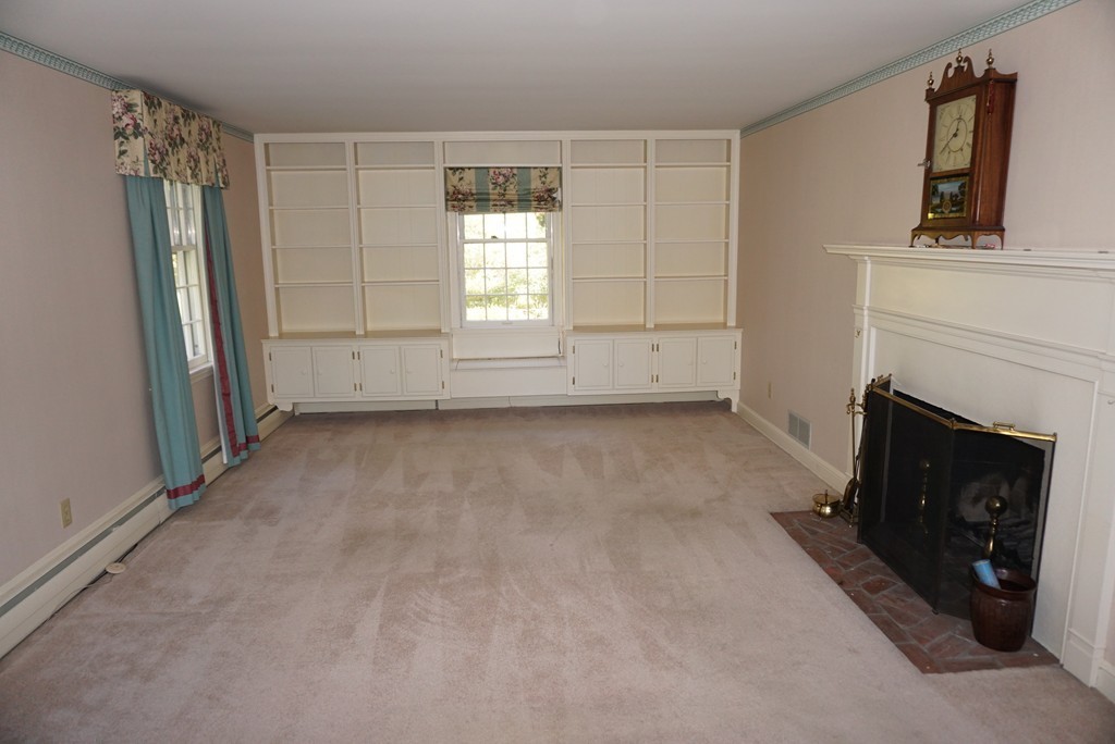 32 McGregory Road Sturbridge, MA 01566 - Photo 10 of 28 a view of empty room with window and fireplace